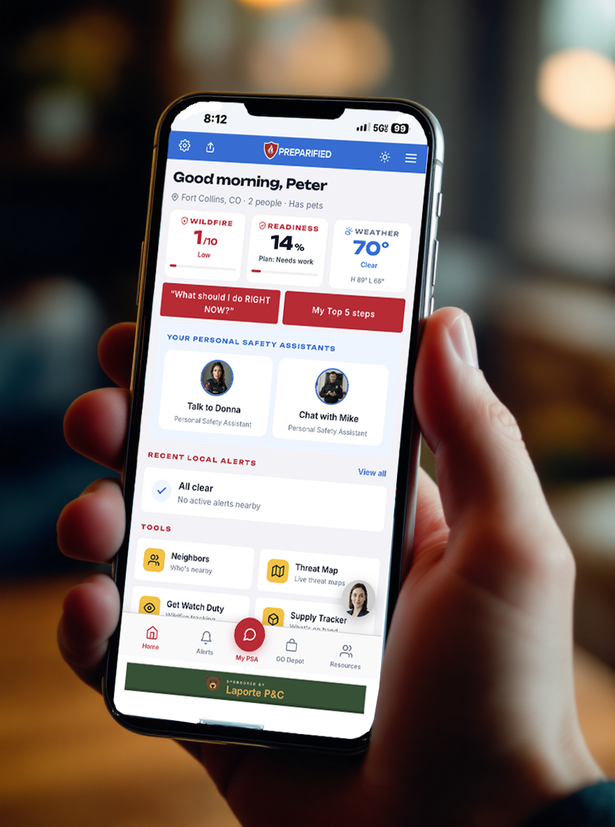 Phone in hand showing PREPARIFIED dashboard with readiness score and active alerts